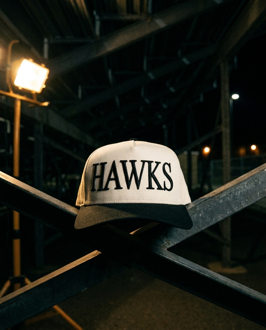 CRBKBK Heath Hawks big puff hat, cream crown, black brim, black raised puff embroidery, under the bleachers at night in Rockwall Texas