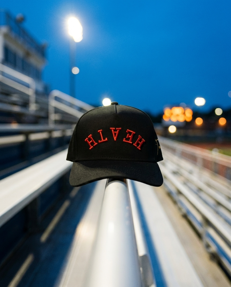 BKBKRD Heath upside down hat, black crown, black brim, red embroidery, on a stadium handrail at blue hour in Rockwall Texas