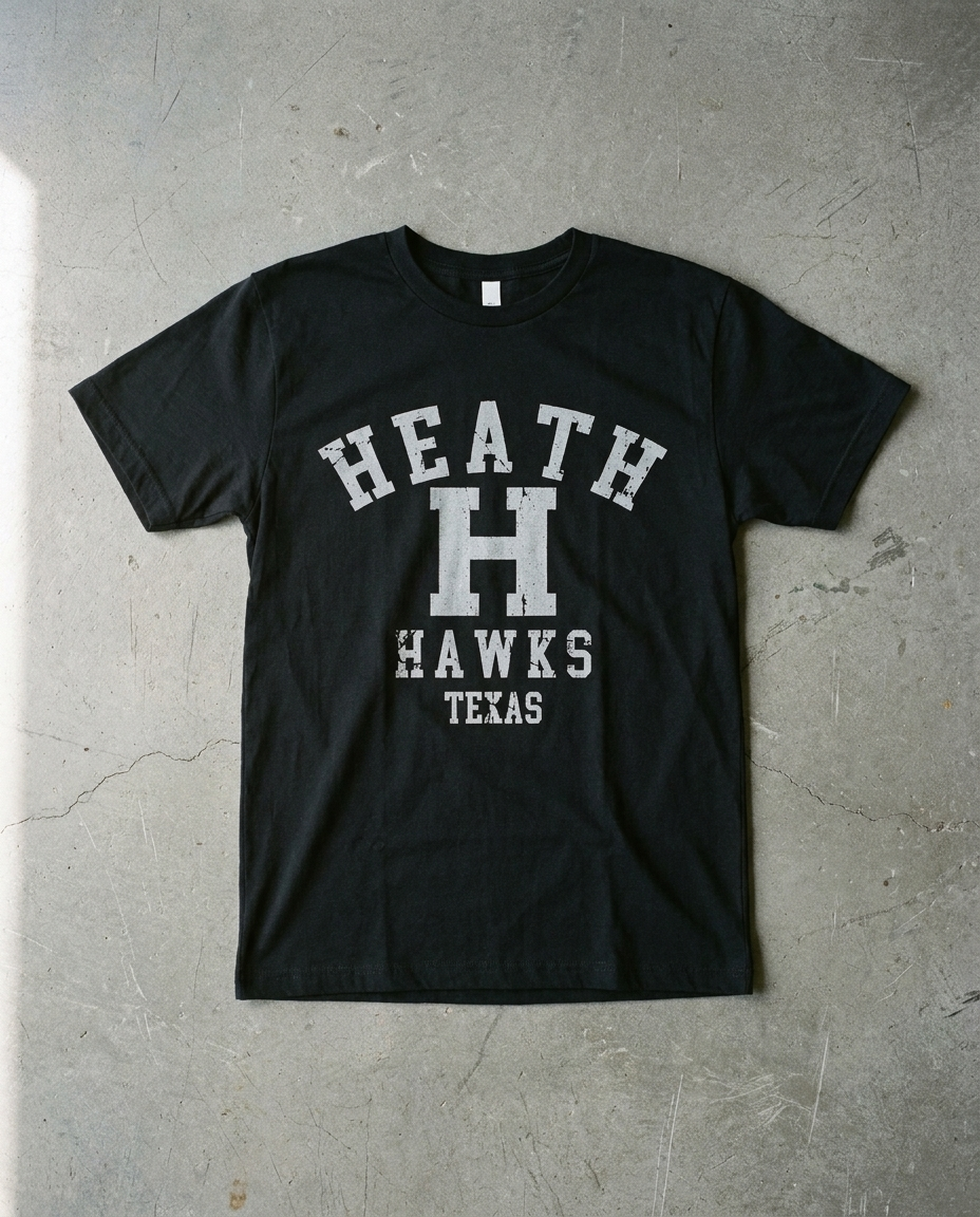 Heath Arched Basic tee in black, distressed HEATH arch over a large H with HAWKS and TEXAS beneath