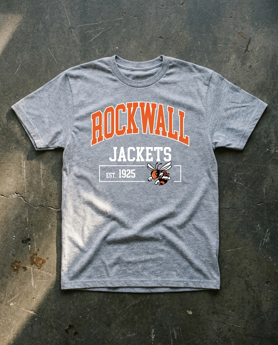 Rockwall Basic Raid Block tee in sport grey, arched ROCKWALL in orange over block JACKETS with EST. 1925 and the hornet boxed underneath