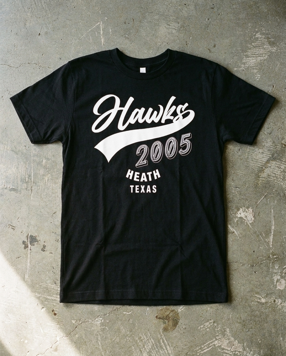 Heath Est. 2005 tee in black, Hawks script riding a tail sweep over 2005 with HEATH TEXAS beneath