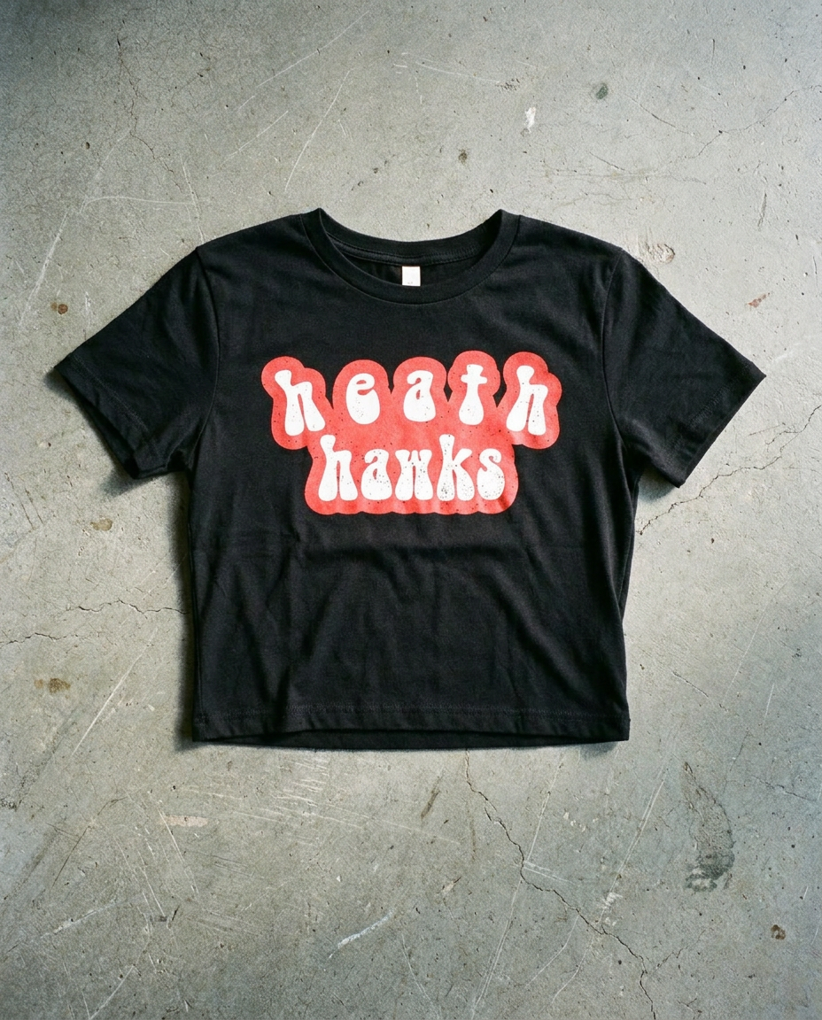 Heath Bubble Groove crop tee in black, lowercase rounded heath hawks in red and cream on a cropped ribbed body