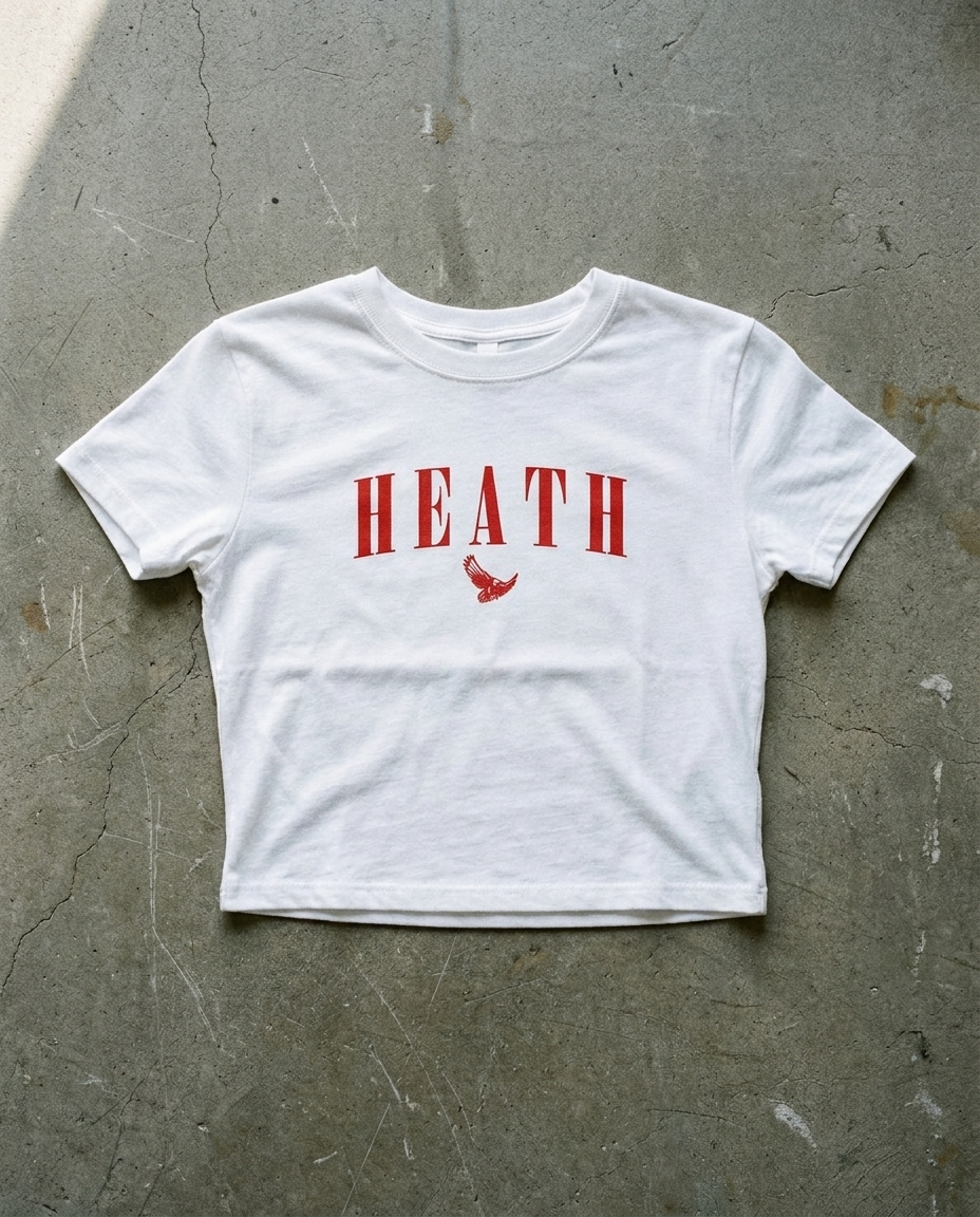Heath Eras crop tee in white, red serif HEATH with the hawk mascot underneath on a cropped ribbed body