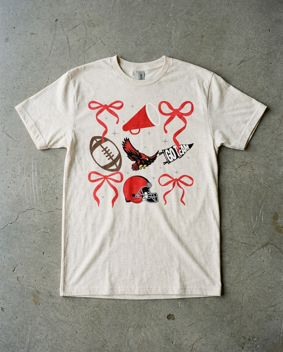 Heath Spirit Checkered tee in natural heather, bows, megaphone, football, hawk, helmet and a GO TEAM pennant scattered across the chest