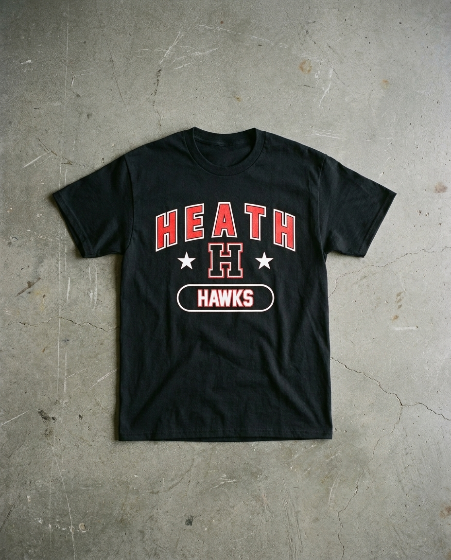 Heath Triumph tee in black, arched HEATH over the H set between two stars with HAWKS in an outlined pill